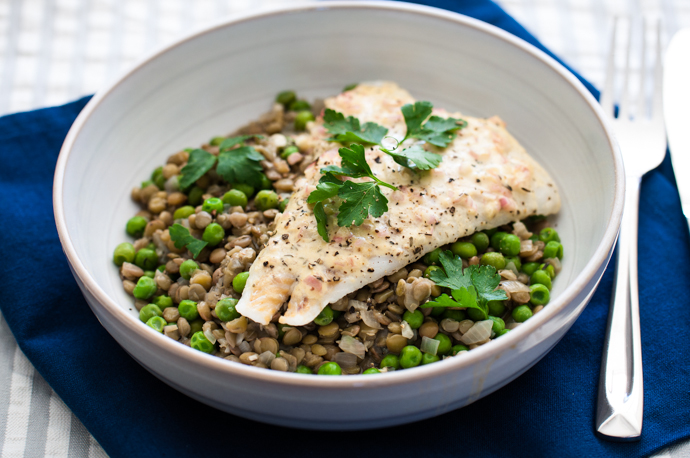 Mustard roasted fish over green lentils, peas, and spinach