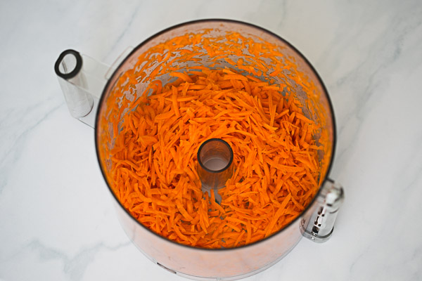 Grated carrots in a food processor